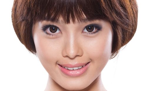 Woman enjoying a peaceful head massage in a serene spa environment.